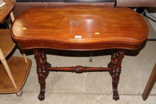 A Victorian mahogany fold over card table