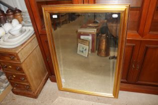 A gilt framed bevel edged modern wall mirror