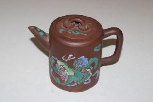 A Chinese tea pot with dragon decoration in colour