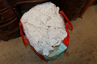 A bag containing three wool blankets and a crochet