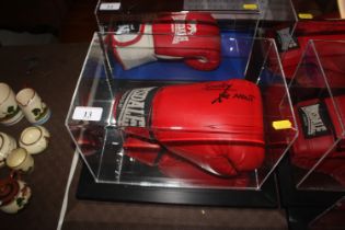 A cased boxing glove with signature