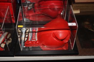 A cased boxing glove, signed Frank Bruno