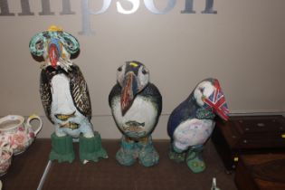 Three pottery models of puffins