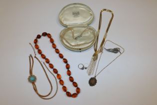 A box of costume jewellery including amber coloure