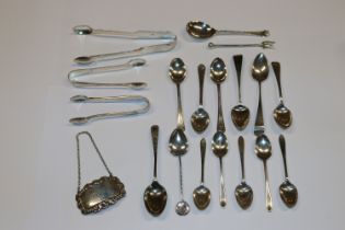 A pair of silver sugar tongs; a silver decanter la