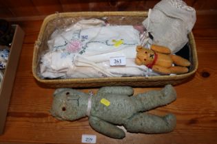 A basket containing various vintage bears, dolls d