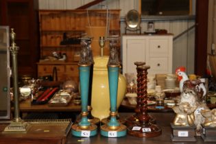 A pair of barley twist candlesticks; two pairs of