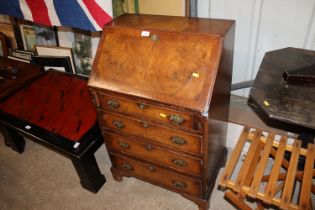 A walnut bureau fitted four long drawers