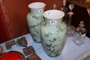 A pair of Oriental green glazed baluster vases