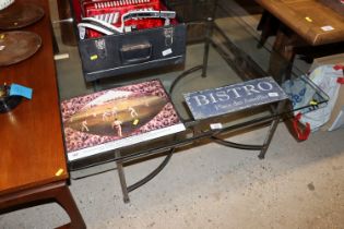 A steel and plate glass topped coffee table