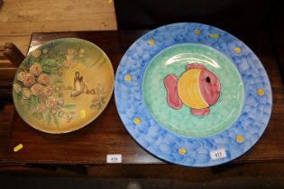 A decorative wall plaque and a large fish platter