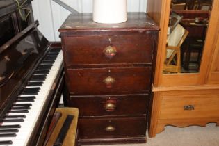 A stained pine chest fitted four long drawers