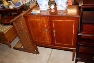 An inlaid mahogany cabinet