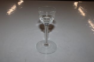 A pan topped wine glass with air twist stem