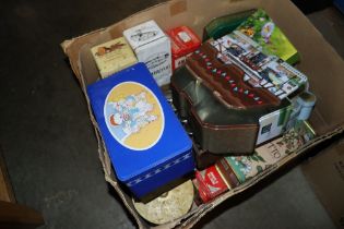 A box containing advertising tins