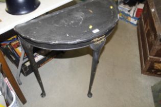 A black painted demi lune hall table