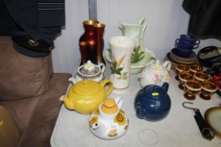 A Le Creuset teapot, four patterned wash jugs with