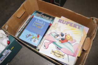 A box containing Rupert annuals etc.