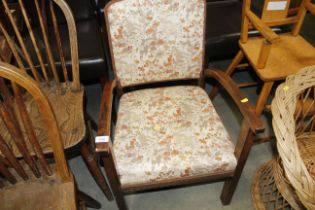 An oak framed and upholstered elbow chair