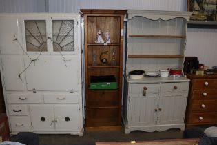 A pine open fronted bookcase of narrow proportions