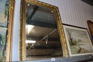 A gilt framed bevel edged wall mirror