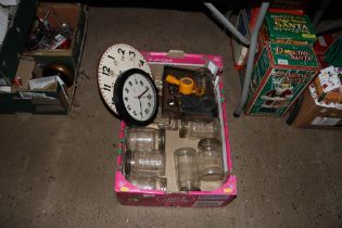 A box containing various glass jars, wall clocks,