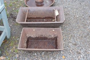 Two cast iron troughs