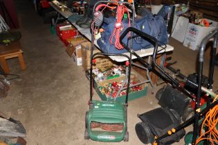 A Qualcast electric cylinder mower lacking grass b