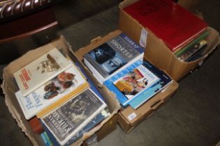 Three boxes containing various books