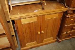 A stripped pine side cupboard