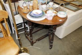 An oak gateleg table together with a white painted slat back dining chair