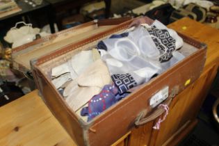 A vintage small suitcase and contents of lady's sc