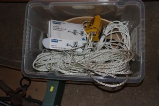 A plastic box with contents of rope, a Yale lock,