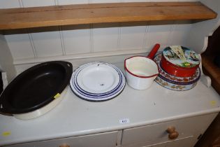 A quantity of enamel plates, saucepan, cooking dis