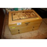 A Mele and Co. jewellery box fitted three drawers,