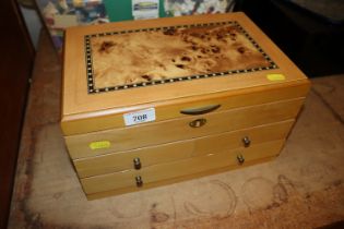 A Mele and Co. jewellery box fitted three drawers,