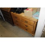 An antique stripped pine chest of two short and th