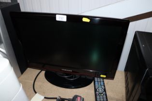 A Samsung flat screen television with remote contr