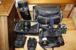 A collection of four various sets of binoculars; a