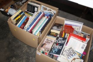 Two boxes containing various books to include Doll