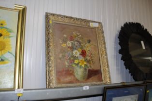 A gilt framed oil on board study of flowers in a v