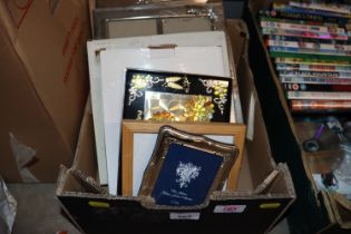 A box of miscellaneous photo frames