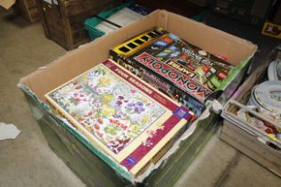 A box containing various board games and puzzles,