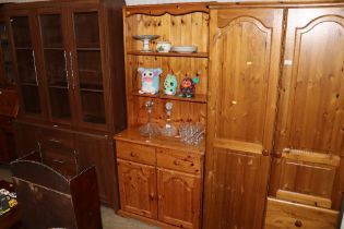 A pine dresser raised on cupboard base fitted two