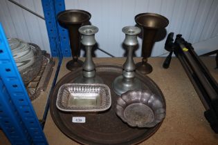 A pair of candlesticks together with a pair of bra