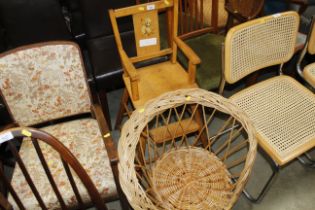 A child's highchair and a small wicker chair