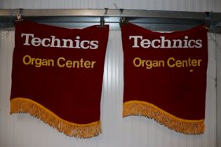 A pair of Techniks Organ Centre advertising banner