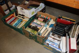 Five boxes containing various books and DVDs