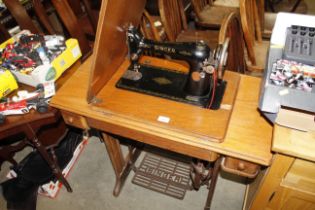 An oak Singer treadle sewing machine, number EB030