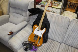 A Squier electric guitar, carrying bag and accesso